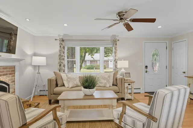 a living room with furniture and a dining table