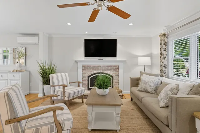 a living room with furniture fireplace and flat screen tv