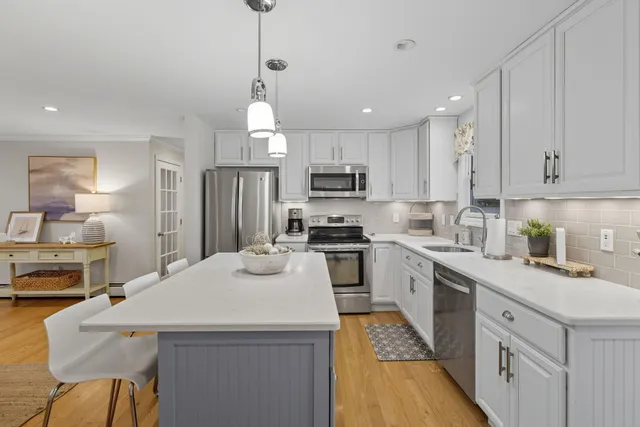 a kitchen with a sink stove and refrigerator