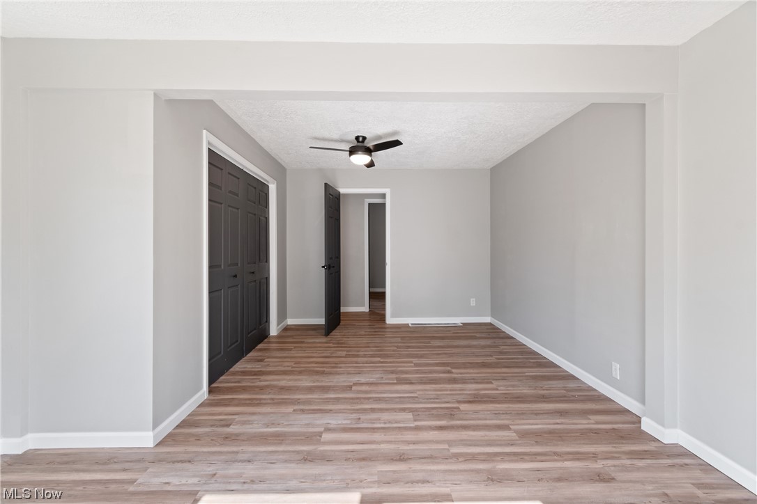 59636 Broadview Road Shadyside, OH 43947 - Photo 19 of 31 Hardwood floored spare room with a textured ceiling and ceiling fan