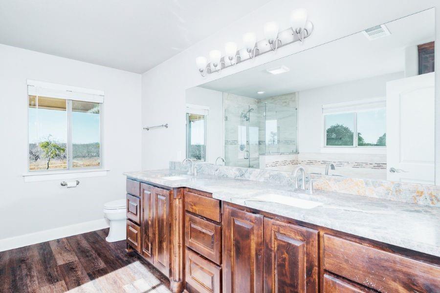 4319 County Road 337 Early, TX 76802 - Photo 14 of 31 a spacious bathroom with a granite countertop sink a mirror and a