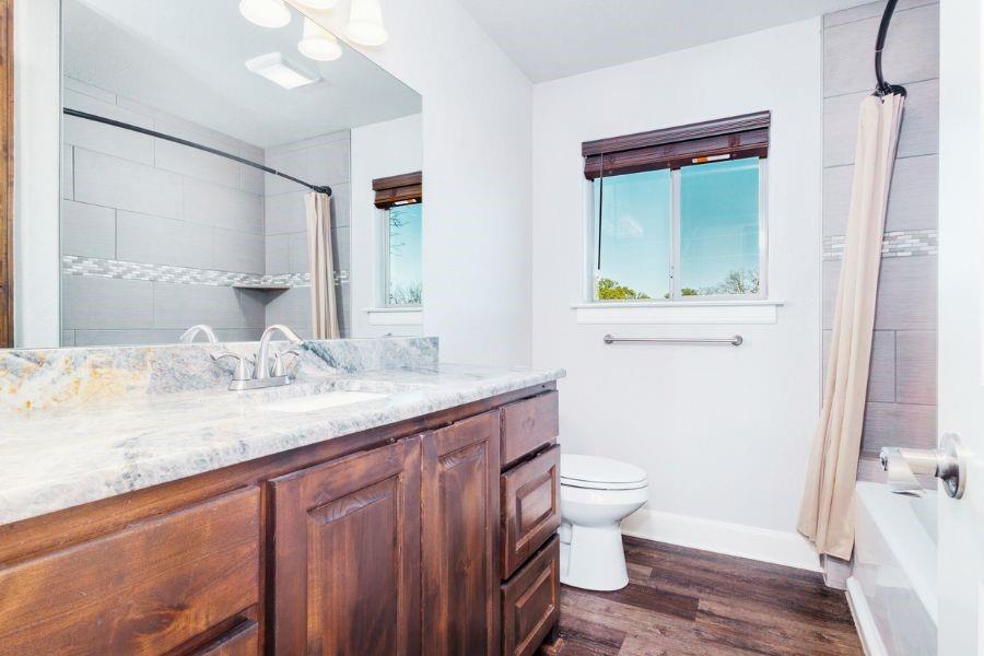 4319 County Road 337 Early, TX 76802 - Photo 19 of 31 a bathroom with a granite countertop sink toilet and shower
