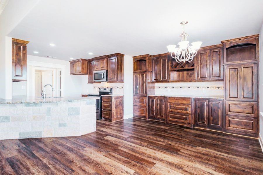 4319 County Road 337 Early, TX 76802 - Photo 7 of 31 a view of a kitchen with kitchen island stainless steel appliances wooden floor and living room view