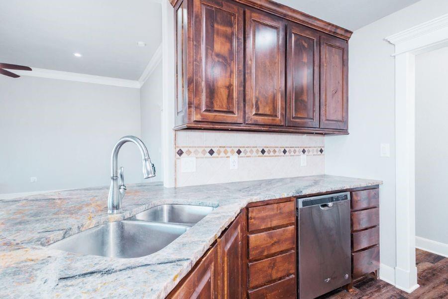 4319 County Road 337 Early, TX 76802 - Photo 10 of 31 a kitchen with granite countertop a sink and cabinets