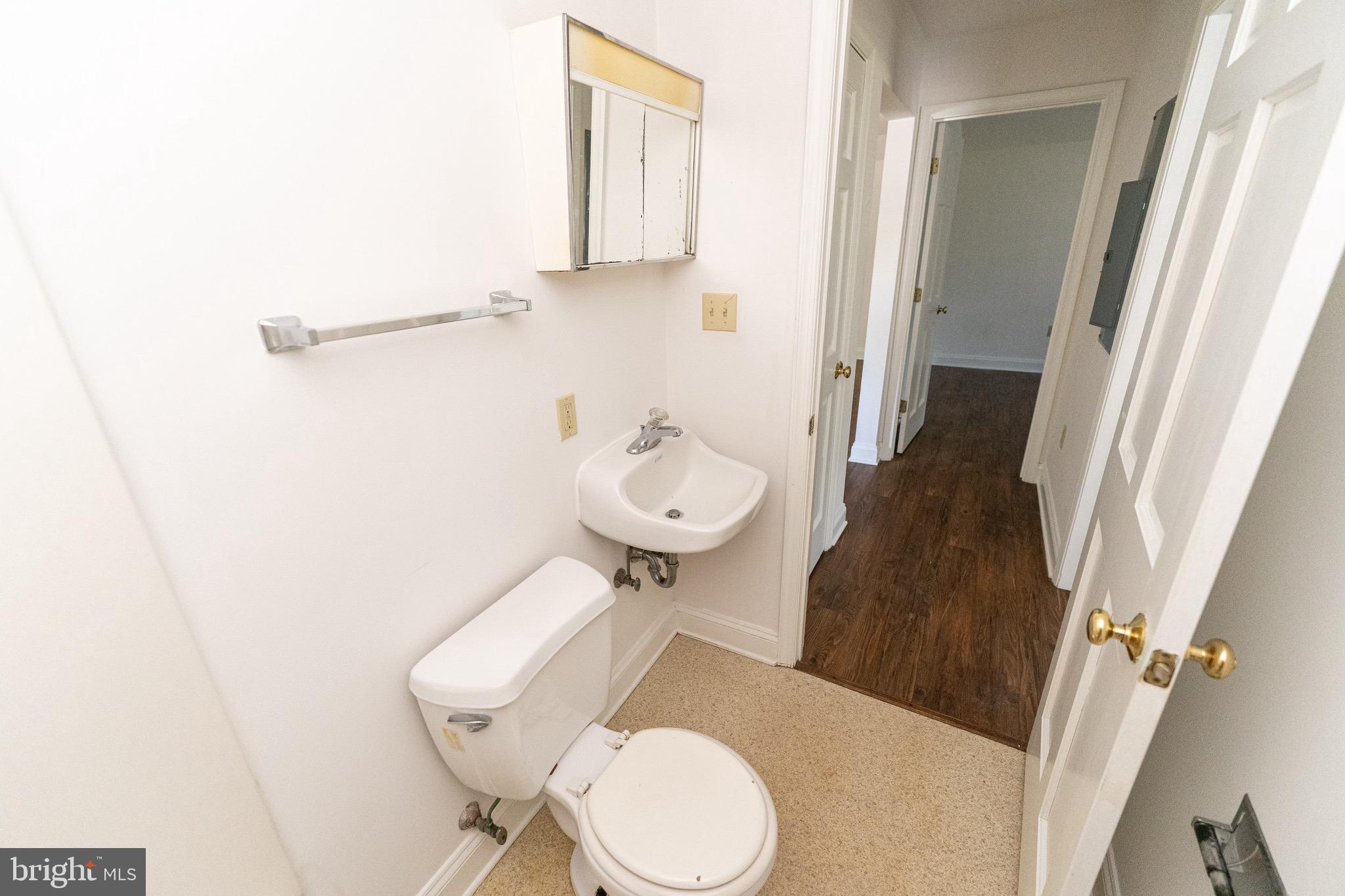 804 Travers Street, Unit 2 Cambridge, MD 21613 - Photo 21 of 26 a bathroom with a toilet and a mirror
