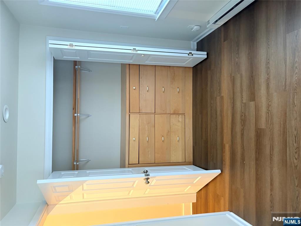 40 Poplar Avenue, Unit 1 Hackensack, NJ 07601 - Photo 8 of 9 a view of an empty room with wooden floor and a window