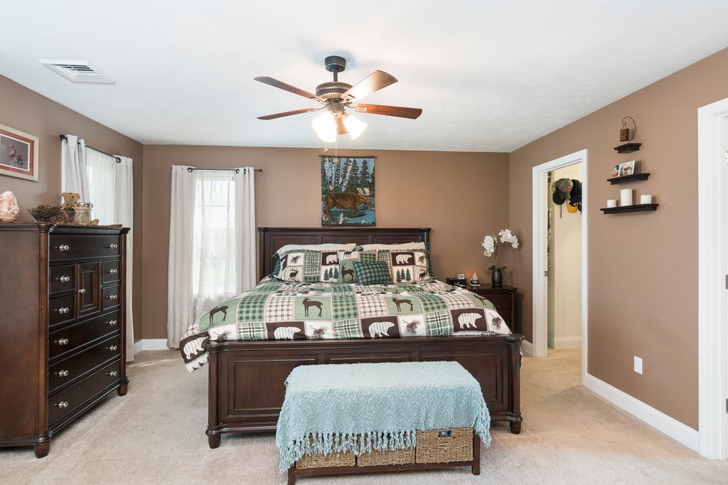 27 Michael Drive Rutland, MA 01543 - Photo 13 of 30 a bed sitting in a room next to a window and dresser