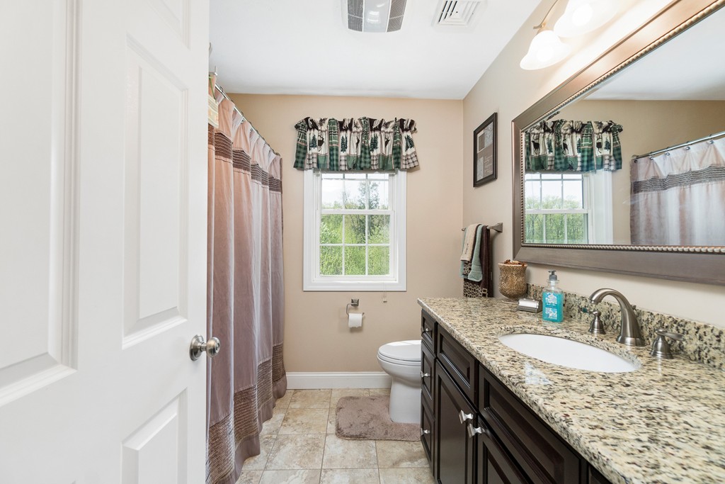 27 Michael Drive Rutland, MA 01543 - Photo 14 of 30 a bathroom with a granite countertop sink and a mirror