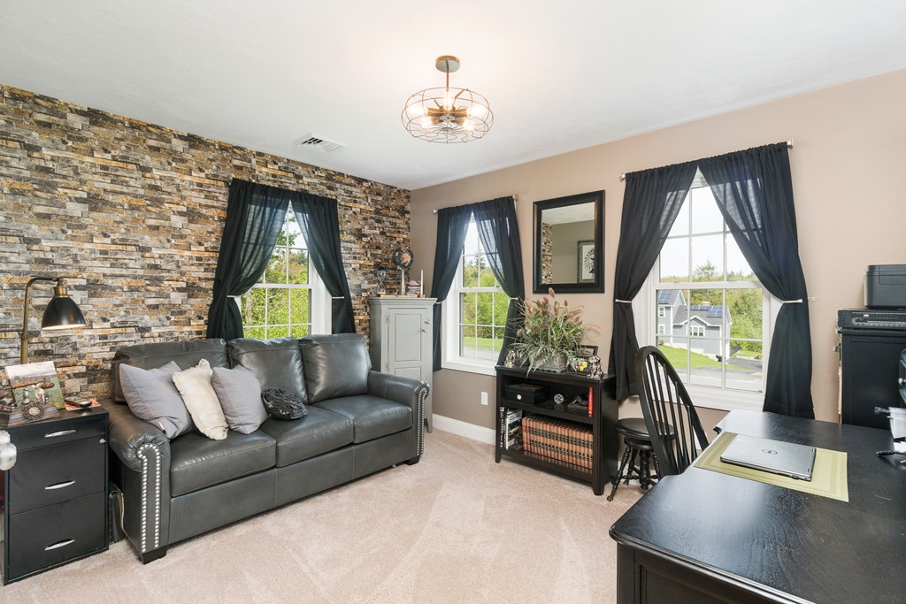 27 Michael Drive Rutland, MA 01543 - Photo 19 of 30 a living room with furniture and a flat screen tv