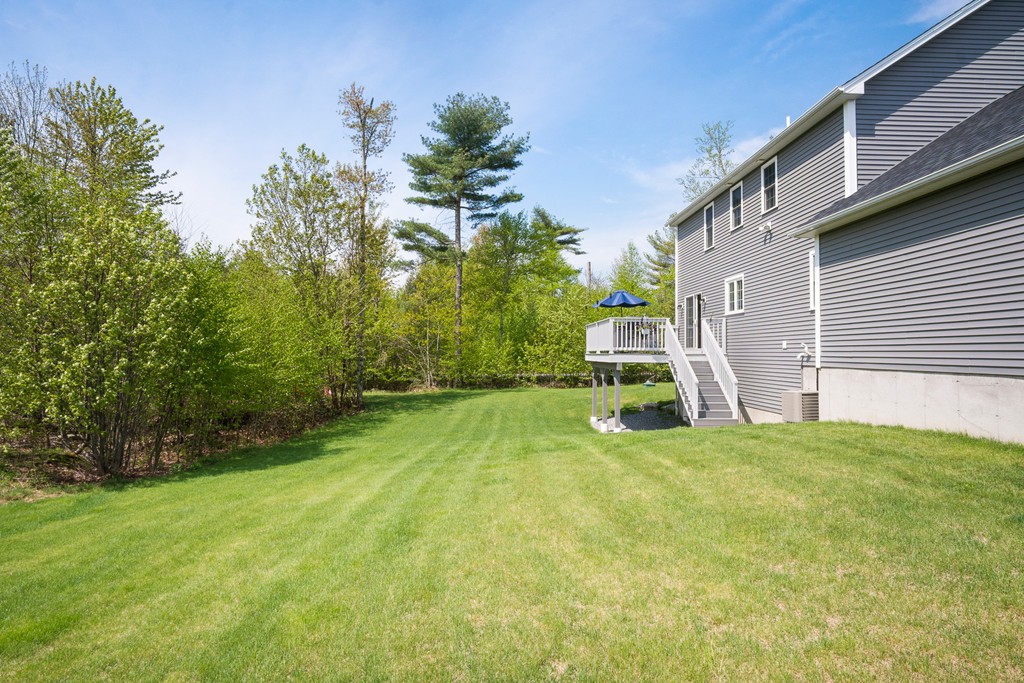 27 Michael Drive Rutland, MA 01543 - Photo 23 of 30 a view of a backyard with table and chairs and potted plants