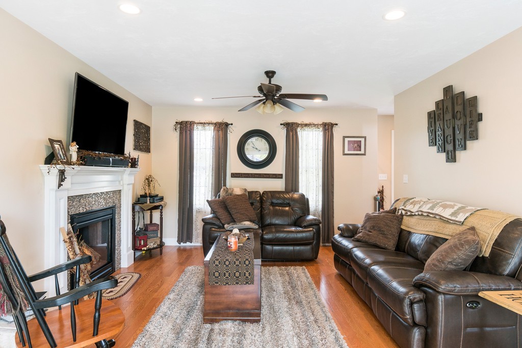 27 Michael Drive Rutland, MA 01543 - Photo 3 of 30 a living room with furniture a flat screen tv and a fireplace