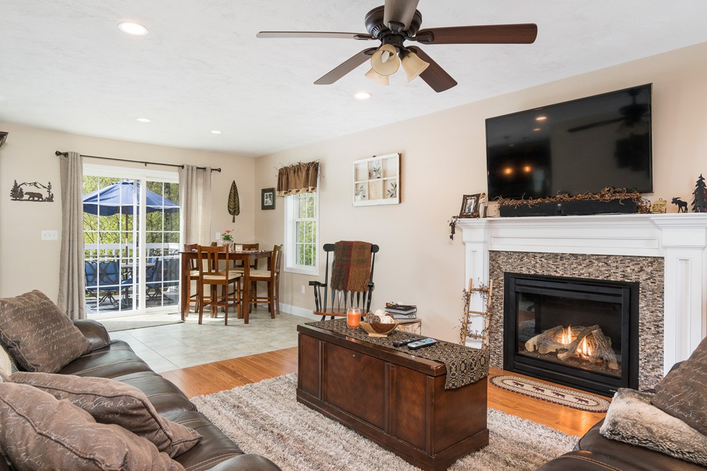 27 Michael Drive Rutland, MA 01543 - Photo 5 of 30 a living room with furniture a flat screen tv and a fireplace