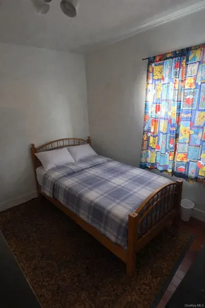 a bedroom with a bed and window