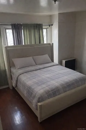 a bedroom with a bed and window