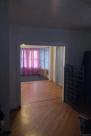 a view of wooden floor and windows in a room