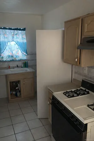 a kitchen with granite countertop a stove and a sink