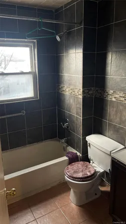 a bathroom with a toilet a sink and bathtub