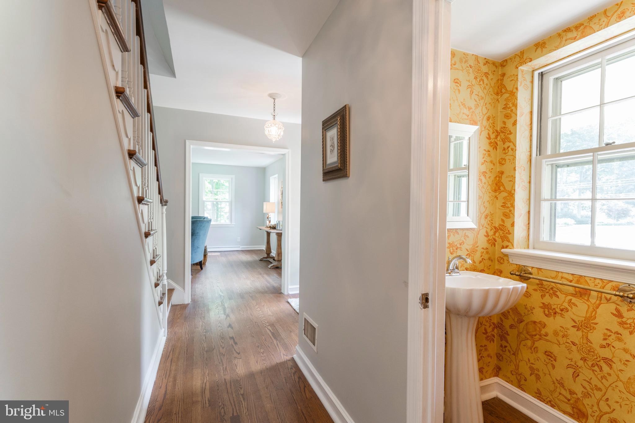 735 Woodcrest Road Wayne, PA 19087 - Photo 5 of 50 a view of a hallway with wooden floor and a bathroom