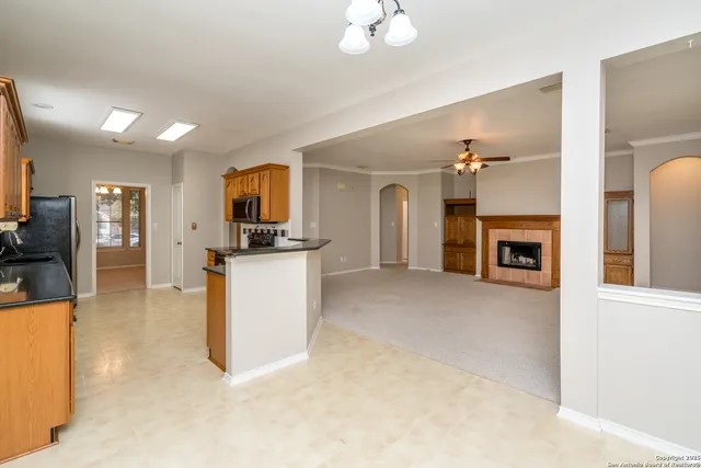 a view of living room with furniture and a fireplace