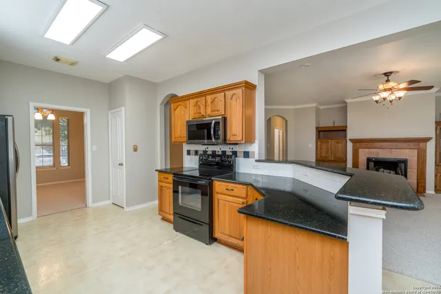 a kitchen with granite countertop a sink and a stove top oven