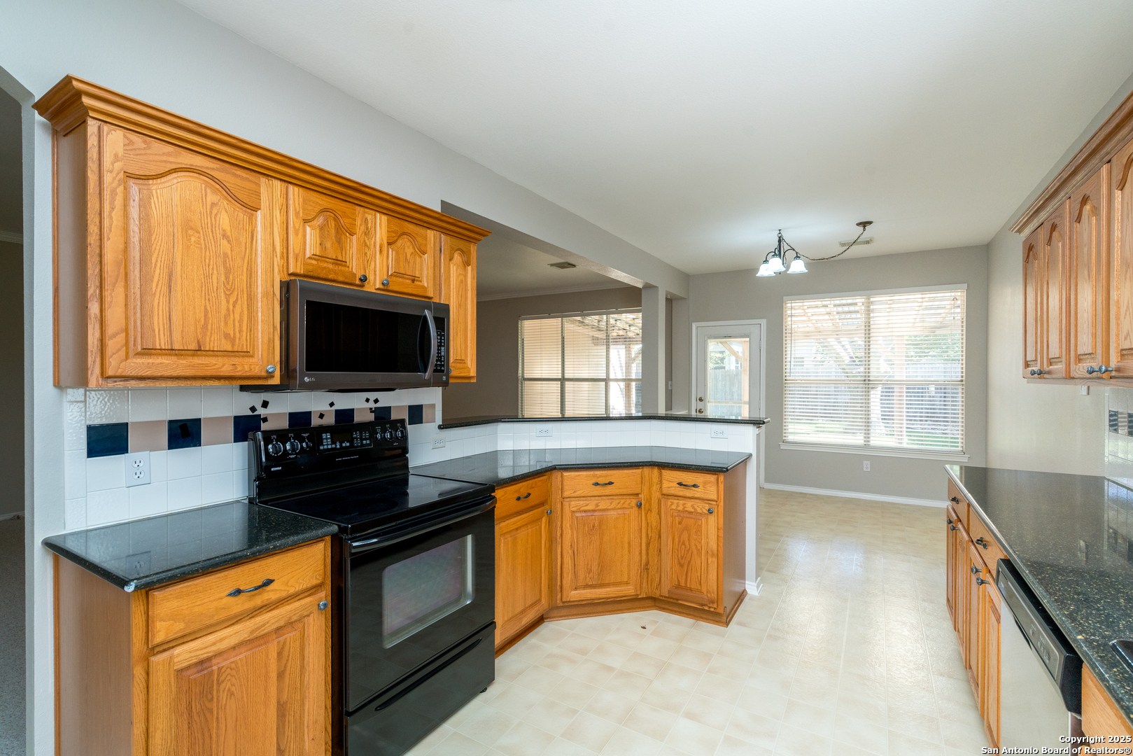 244 Turkey Tree Cibolo, TX 78108 - Photo 15 of 48 a kitchen with stainless steel appliances granite countertop a stove a sink and a microwave