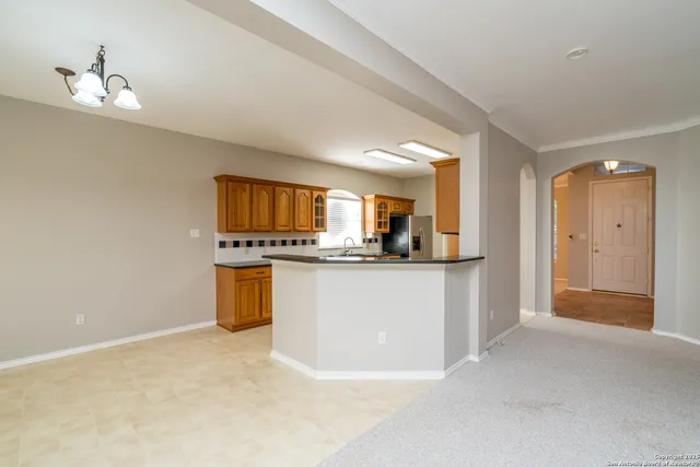 a view of kitchen with refrigerator sink and cabinets