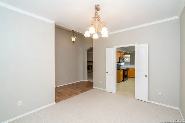 an empty room with kitchen view