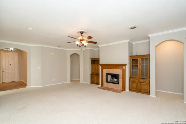 a view of an empty room with a fireplace