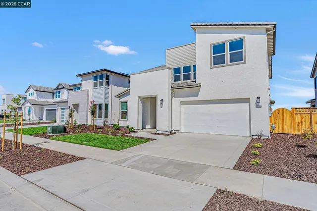 a view of a white house with a yard and table and chairs