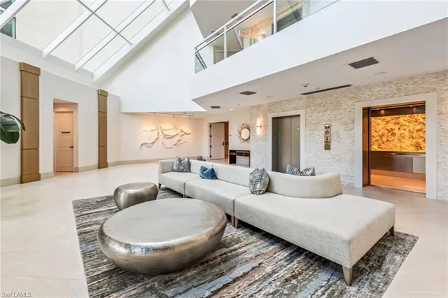 a living room with furniture a rug and a large window