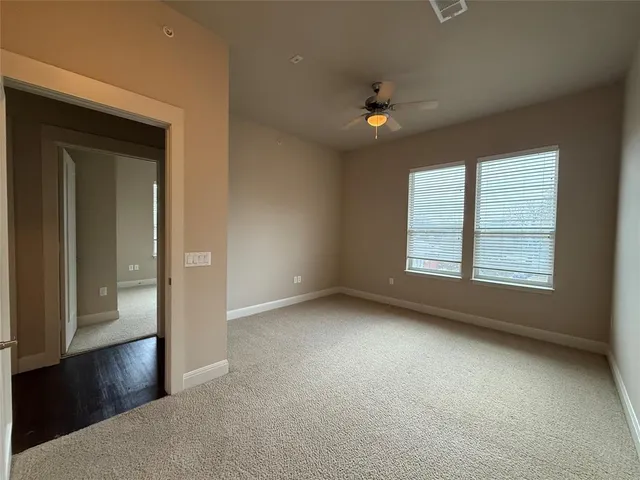 an empty room with windows and closet