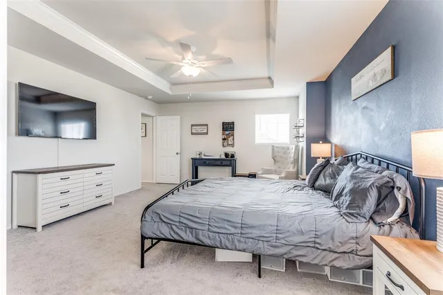 a bedroom with a bed and a dresser in it