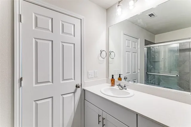 a bathroom with a sink double vanity and a mirror