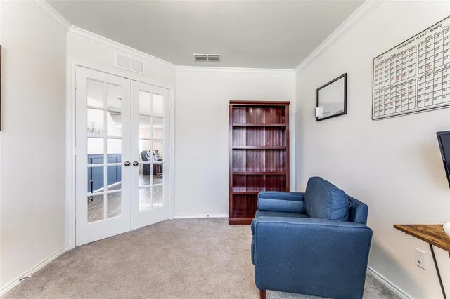 a living room with furniture and a book shelf