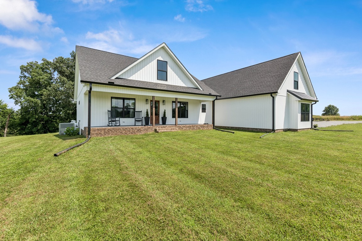 a front view of house with yard and green space