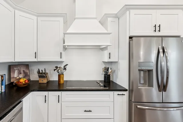 a kitchen with stainless steel appliances granite countertop a refrigerator and a sink