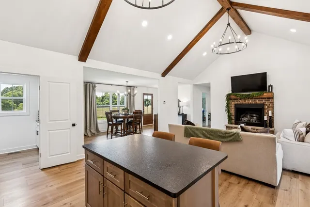 a living room with furniture a dining table and a fireplace