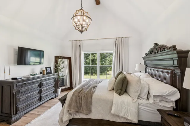 a bedroom with a bed and a flat screen tv