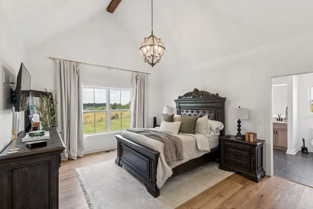 a living room with a bed furniture and a flat tv screen