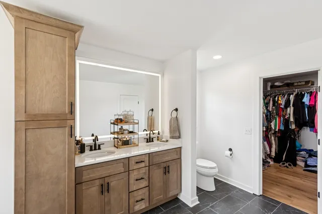a bathroom with a double vanity sink and a mirror