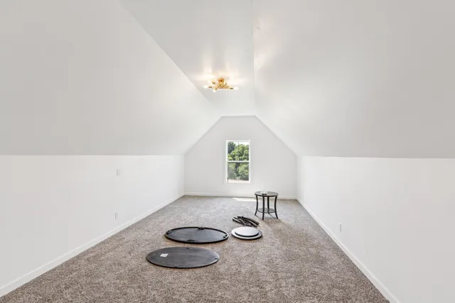 a view of a room with two chandeliers and a window