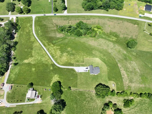 an aerial view of a residential houses with outdoor space and street view
