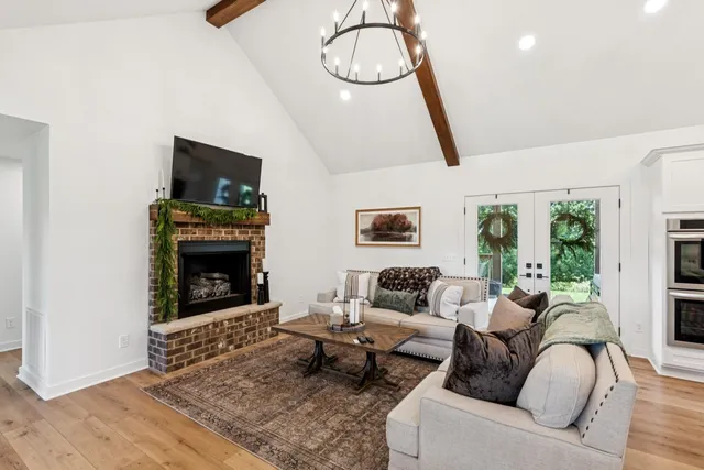 a living room with furniture a flat screen tv and a fireplace