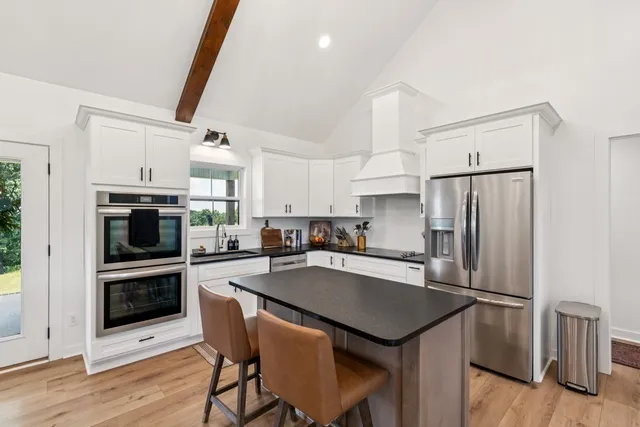 a kitchen with refrigerator cabinets and wooden floor