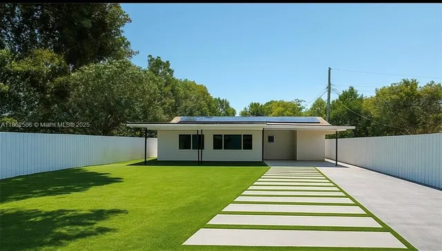 a front view of a house with a garden and yard