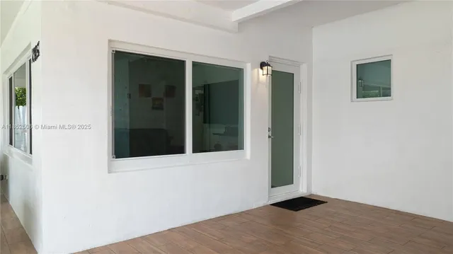 an empty room with wooden floor and a window