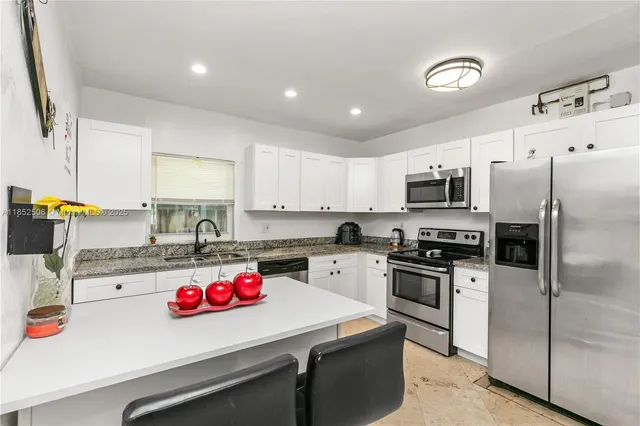 a kitchen with a sink a stove and refrigerator