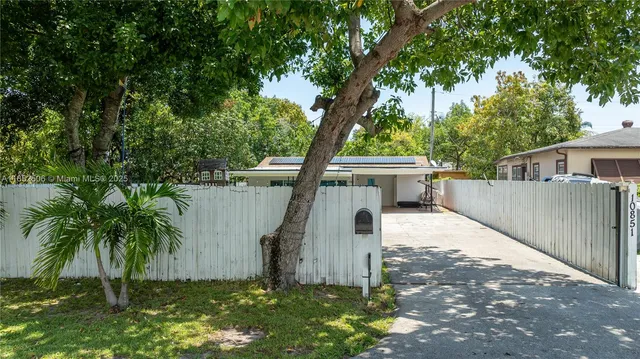 a view of a house with a tree in the background