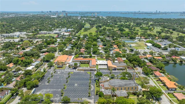an aerial view of residential houses with outdoor space and trees