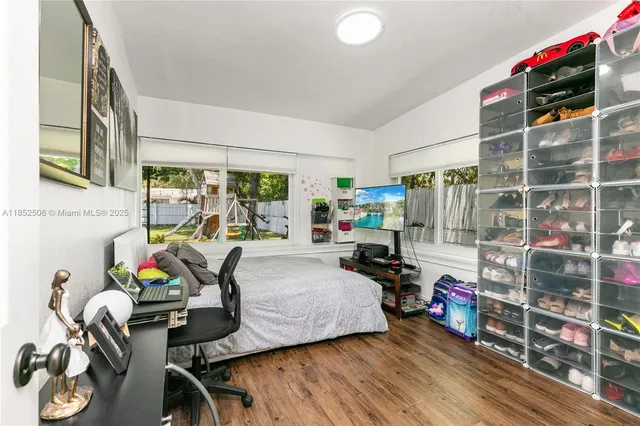 a bedroom with furniture and a flat screen tv